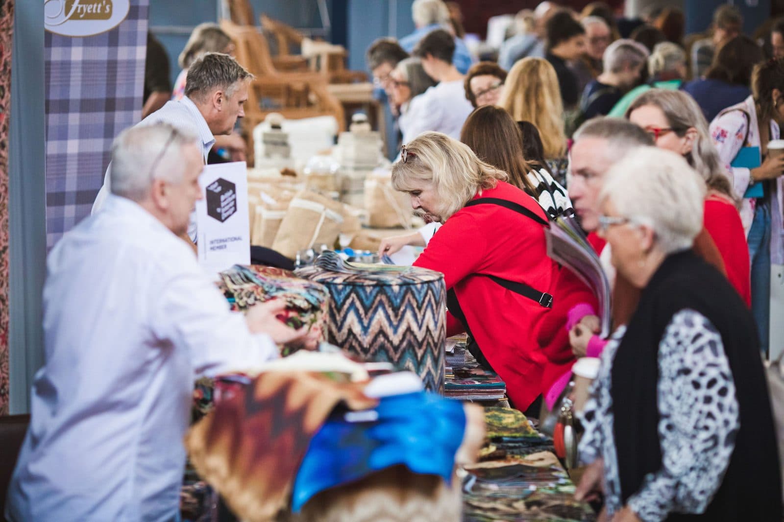 Visitors at a fabric stand at a previous Festival of Upholstery
