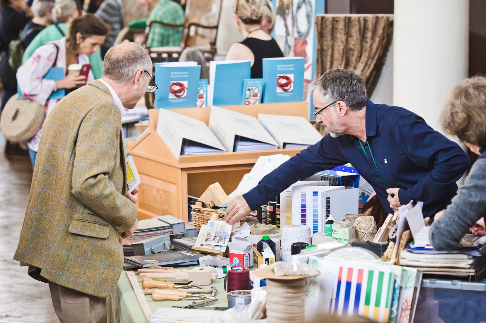 A supplier stand at a previous Festival of Upholstery, with tools, threads and samples laid out for visitors