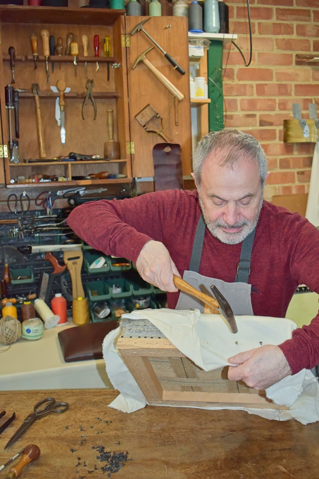 Franco Marinelli, author of Chair Upholstery, at his workbench