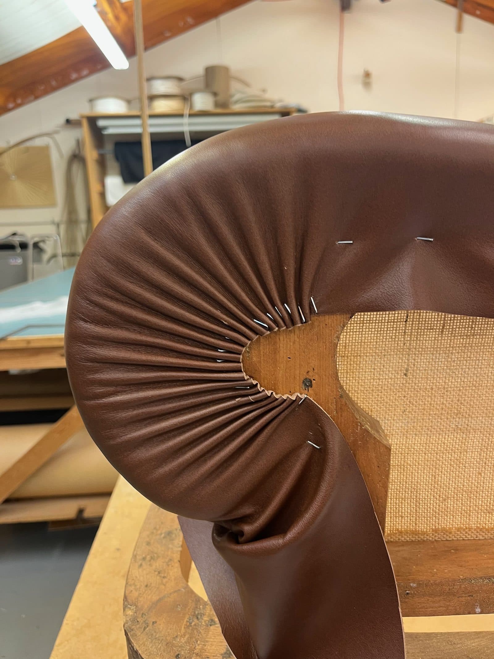 Leather pleated around the scroll of a top-stuffed arm on Annabel Lloyd's winning chair