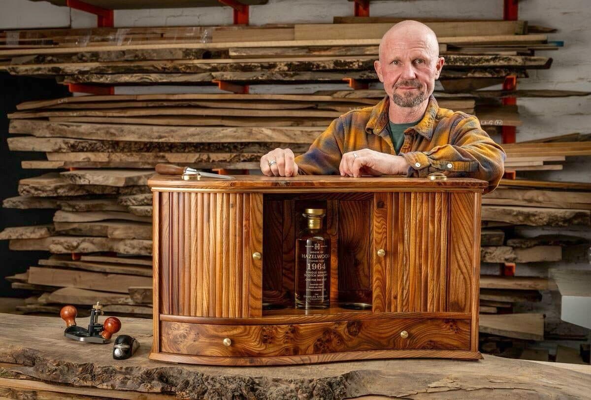 The finished tambour whisky cabinet in Scottish elm, open, with a bottle inside