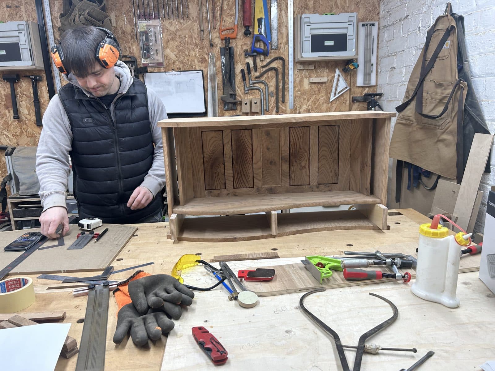 Tony Blacker at work on the cabinet in the workshop
