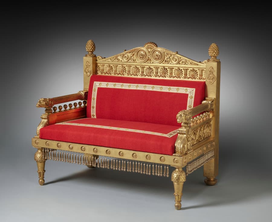 Neoclassical gilt-wood settee of about 1802 to 1807 with a carved frieze, central pediment and upholstered seat, designed by Thomas Hope
