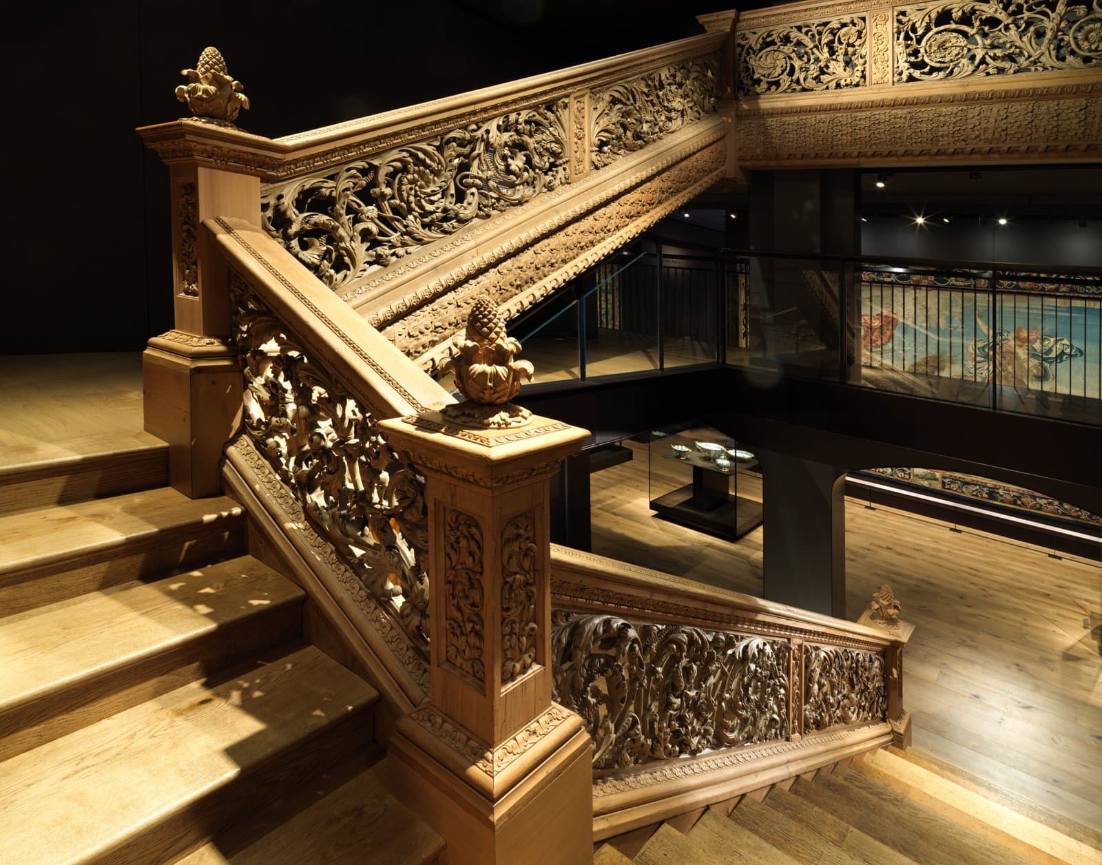 Carved staircase with pierced foliate balustrade panels and pinecone finials on the newel posts, about 1677 to 1680, from Cassiobury Park, Hertfordshire