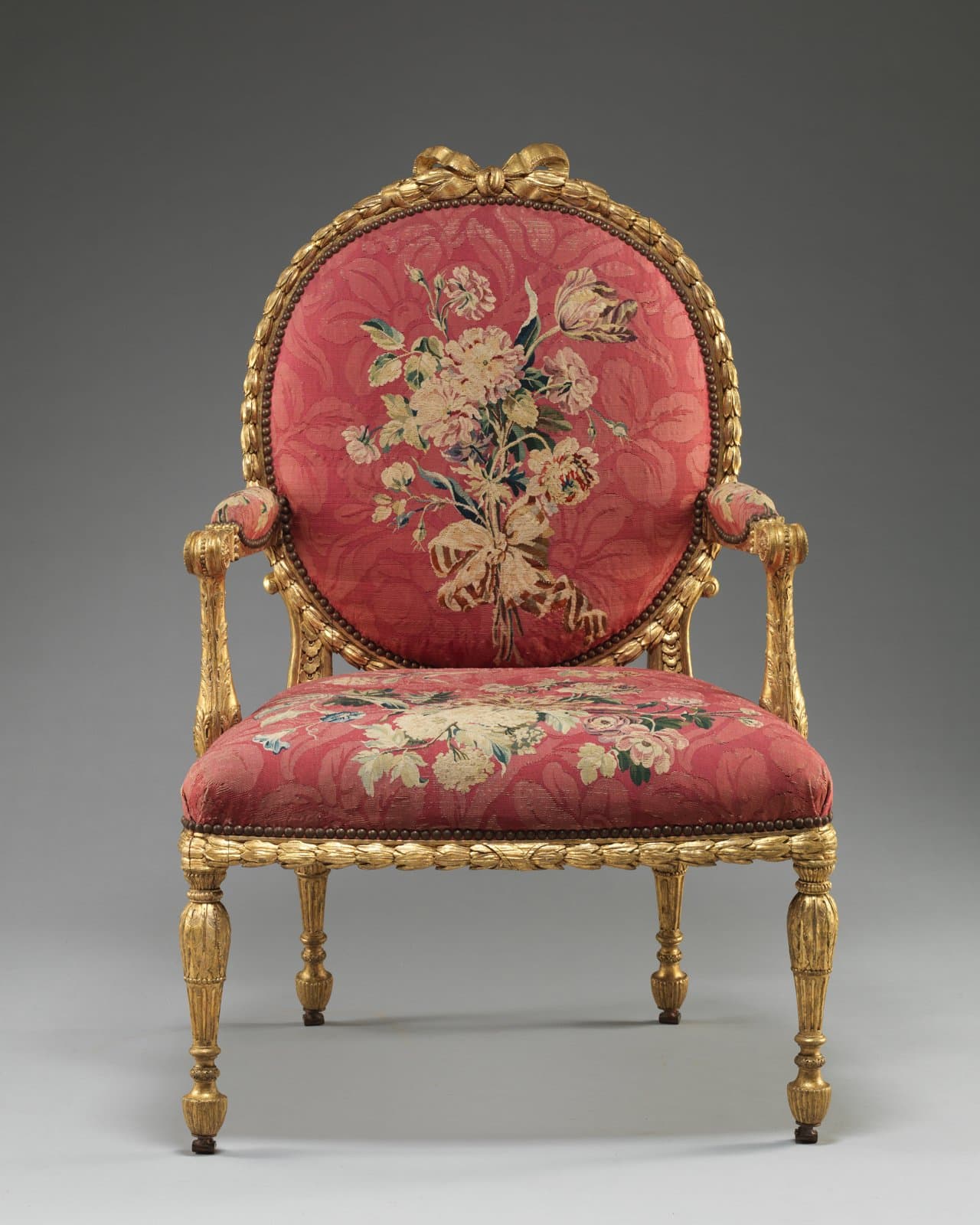 Gilded armchair with oval back and floral tapestry cover, 1769 to 1771, John Mayhew