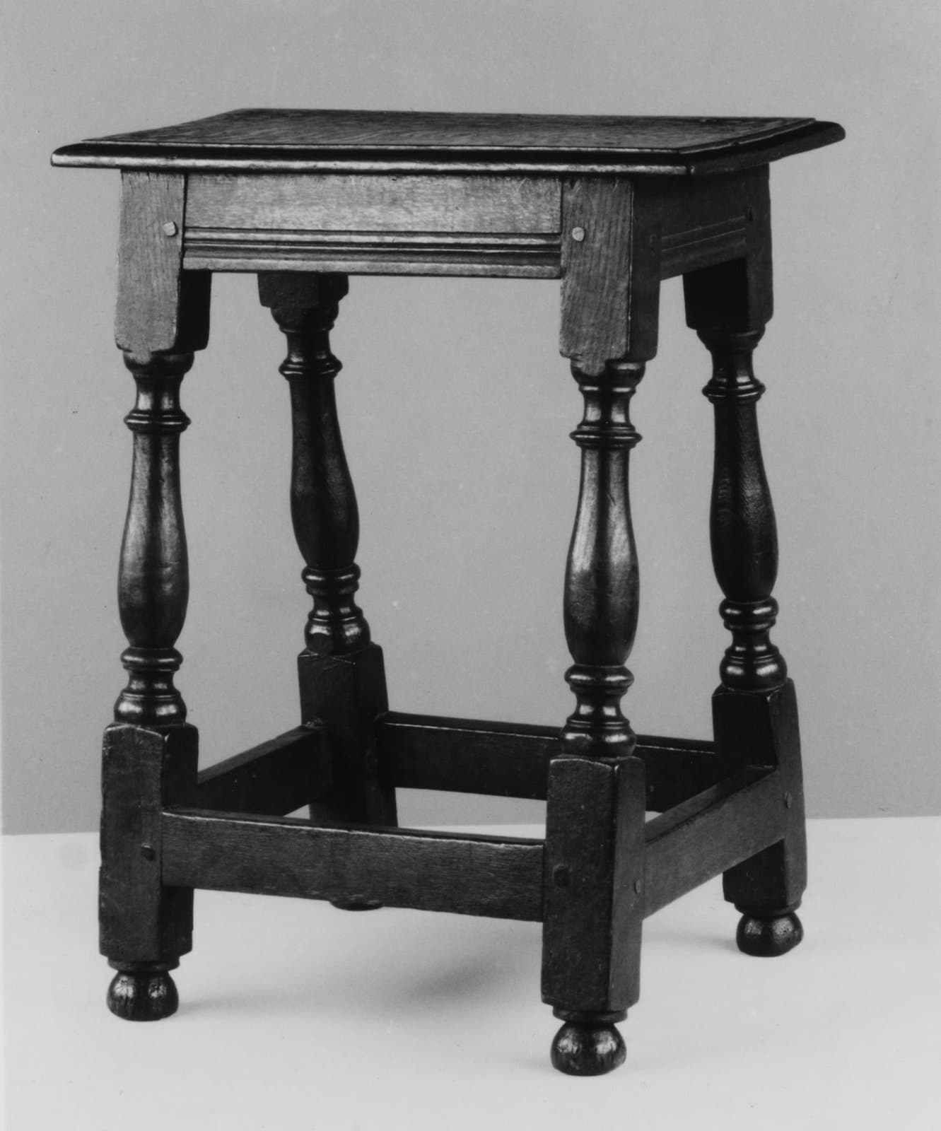 English oak joint stool of 1650 to 1700 with turned legs, moulded rails and low stretchers