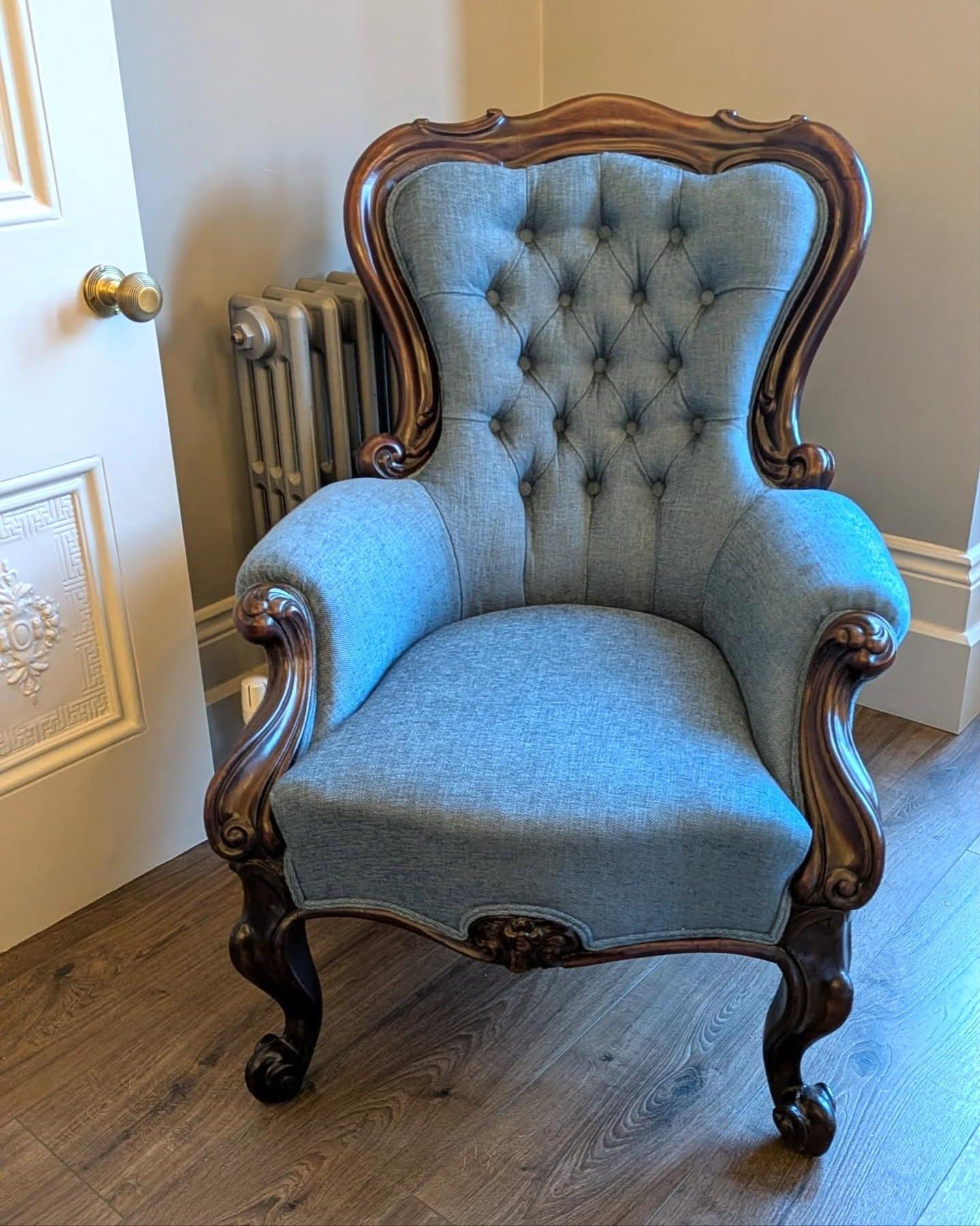The finished Victorian chair in a blue-grey wool with a deep-buttoned back